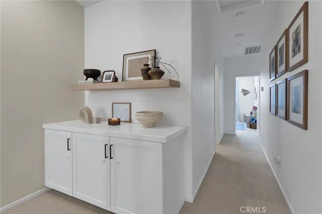 a hallway view with cabinets