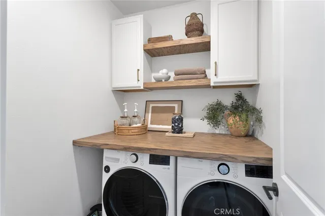 a utility room with sink dryer and washer