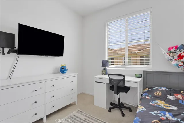 a view of a livingroom with workspace and a window