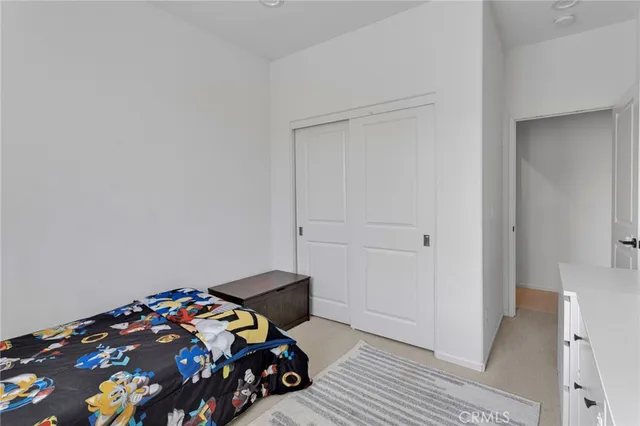 a bedroom with a bed and dresser