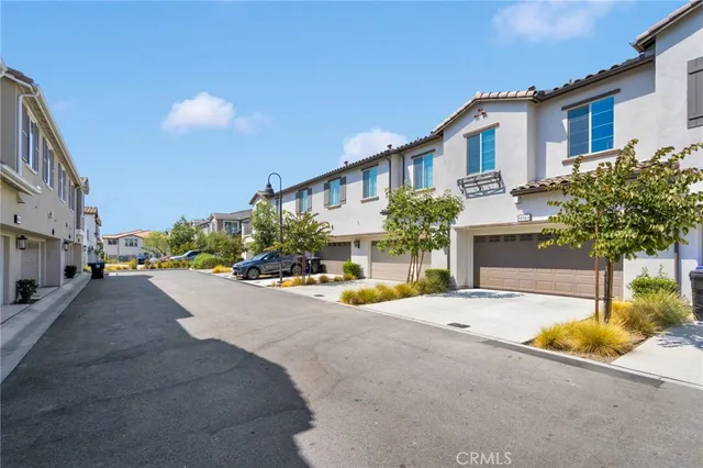 a front view of a house with yard and tree s