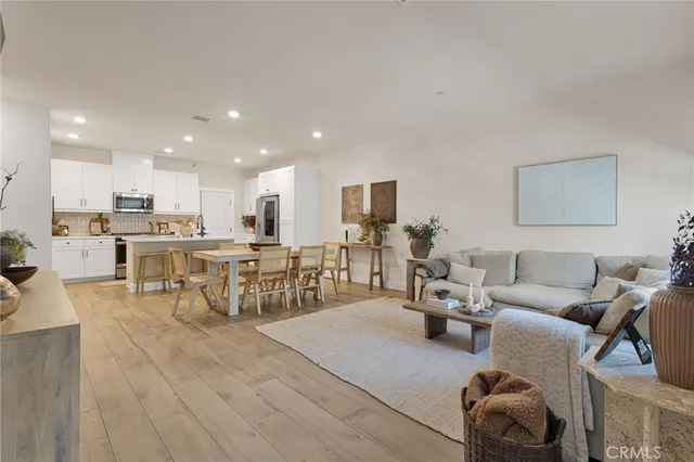 a living room with furniture and kitchen view