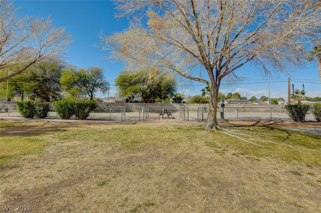 3318 North Decatur Boulevard, Unit 2072 Las Vegas, NV 89130 - Photo 41 of 50 A community park with mature trees and a fenced-in area offers a tranquil outdoor escape.