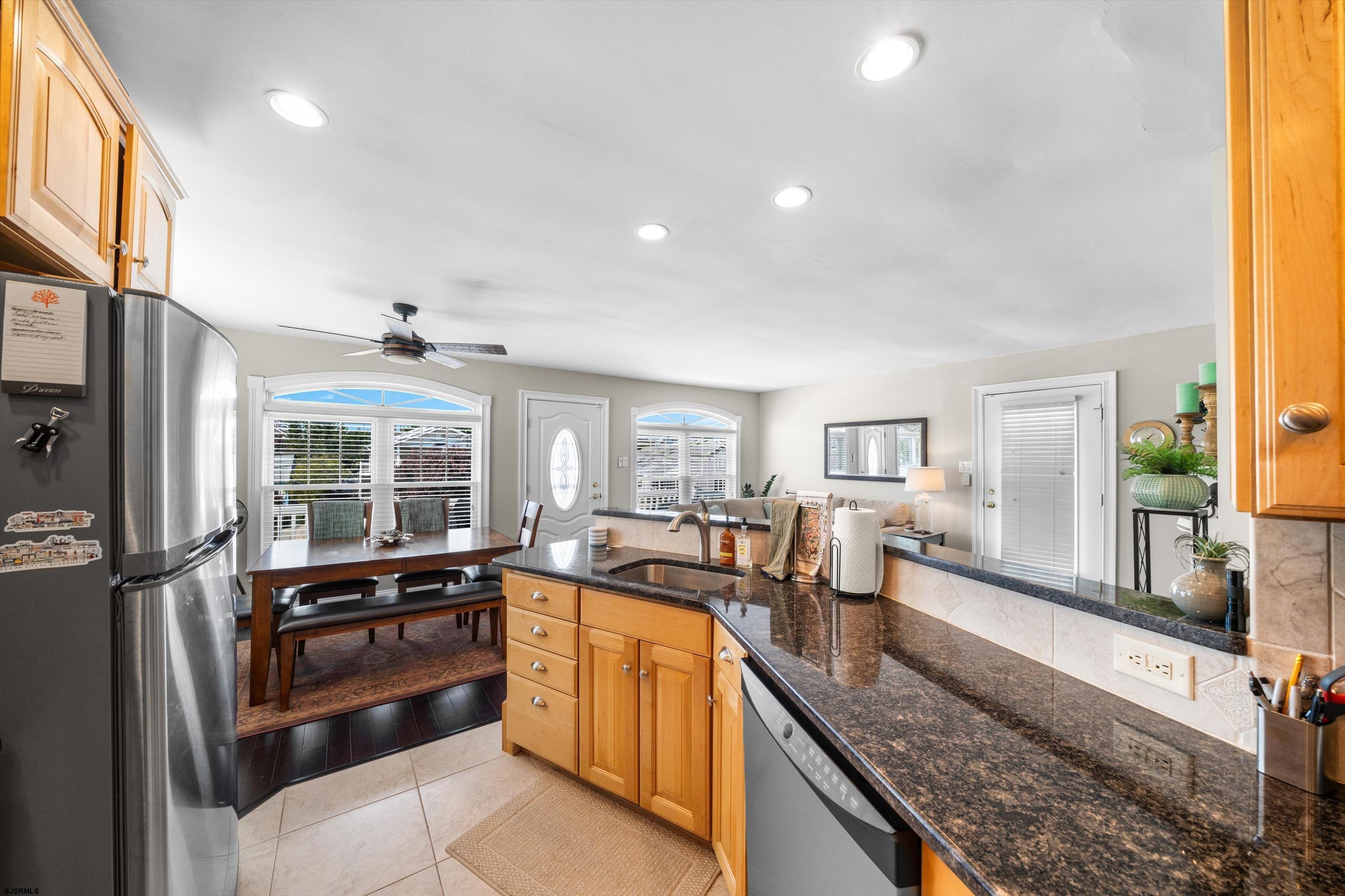 51 Simpson Road, Unit 2 Ocean City, NJ 08226 - Photo 19 of 43 a large kitchen with granite countertop a large window and stainless steel appliances
