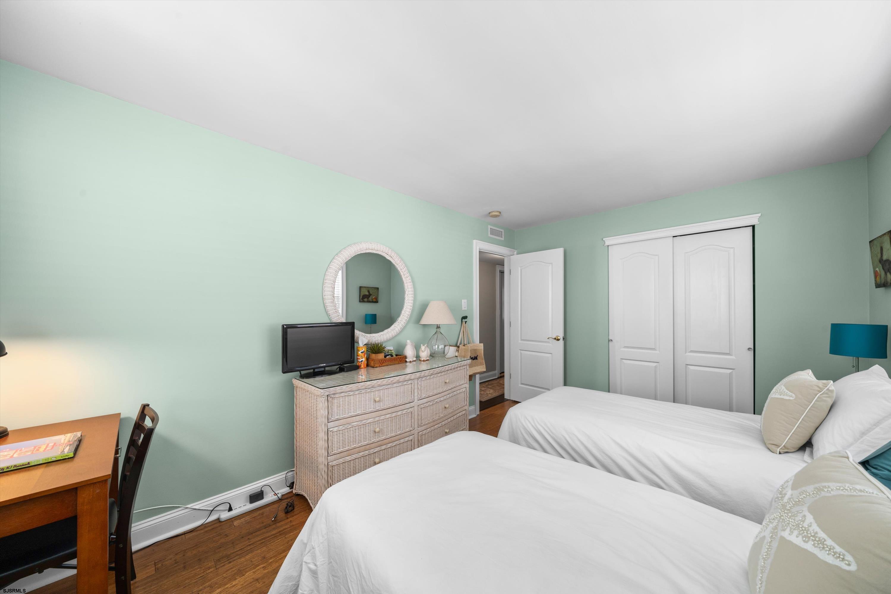 51 Simpson Road, Unit 2 Ocean City, NJ 08226 - Photo 31 of 43 a bedroom with a bed and a table