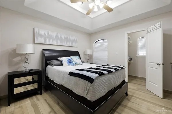 a bedroom with a bed and a flat screen tv
