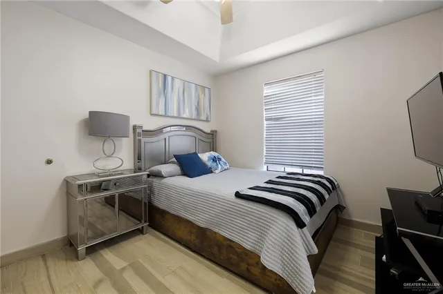a bathroom with a granite countertop sink toilet a mirror and shower