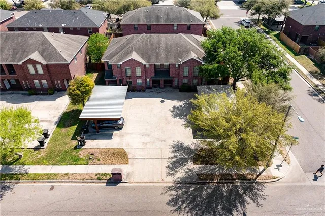 an aerial view of a house with a yard and garden