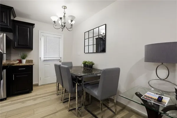 a kitchen with granite countertop a sink stainless steel appliances and cabinets