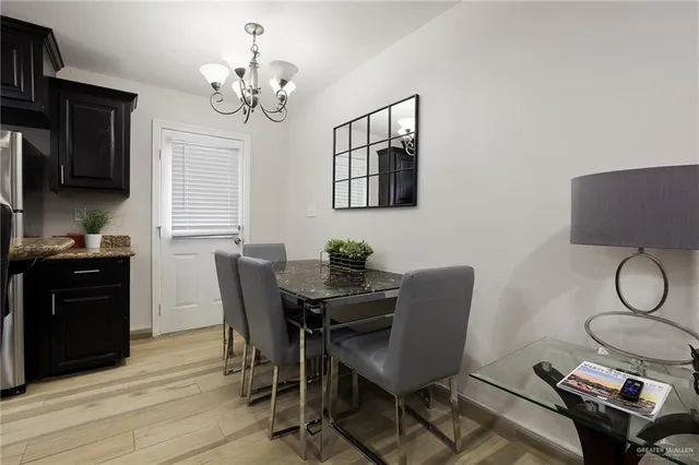 a kitchen with granite countertop a sink stainless steel appliances and cabinets