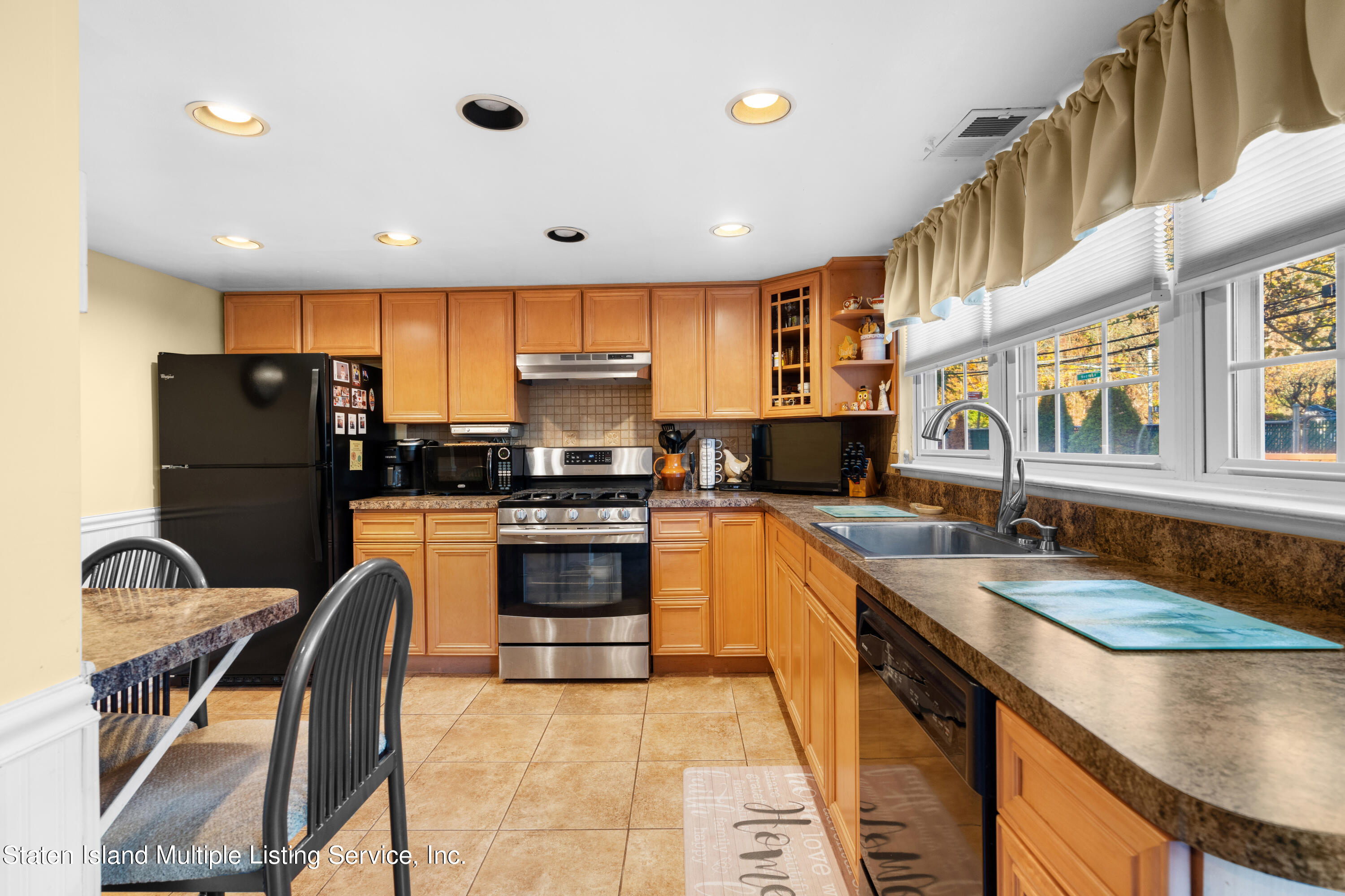 47 Hampton Green Staten Island, NY 10312 - Photo 8 of 38 a kitchen with stainless steel appliances granite countertop a sink a stove and a refrigerator