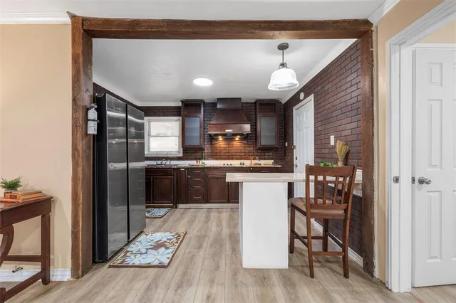 a kitchen with a refrigerator a sink and cabinets