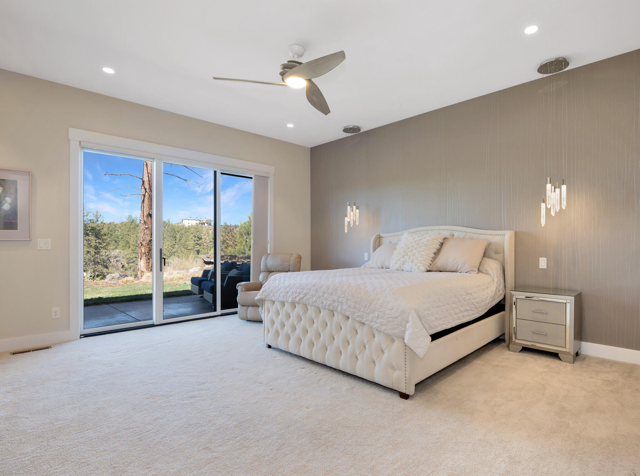 60871 River Rim Drive Bend, OR 97702 - Photo 25 of 42 a spacious bedroom with a large bed and a large window