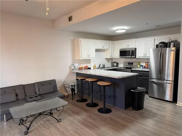 a kitchen with a sink appliances and cabinets