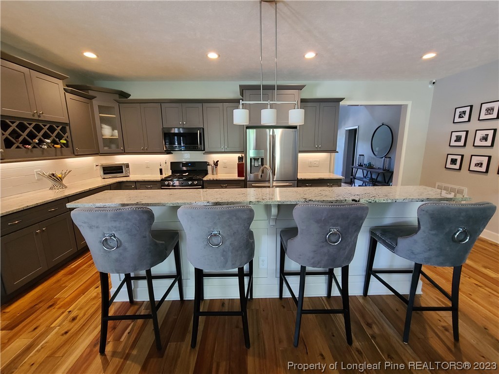 215 Devon Circle Aberdeen, NC 28315 - Photo 11 of 35 a kitchen with granite countertop a sink and chairs