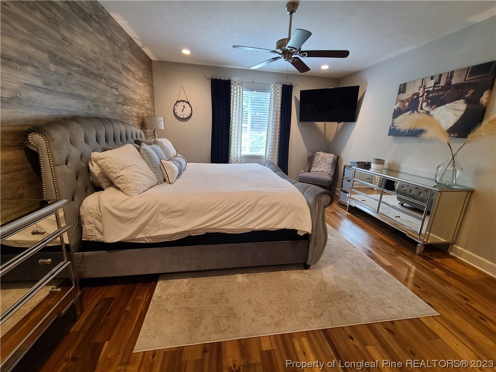 215 Devon Circle Aberdeen, NC 28315 - Photo 16 of 35 a bedroom with a bed and wooden floor