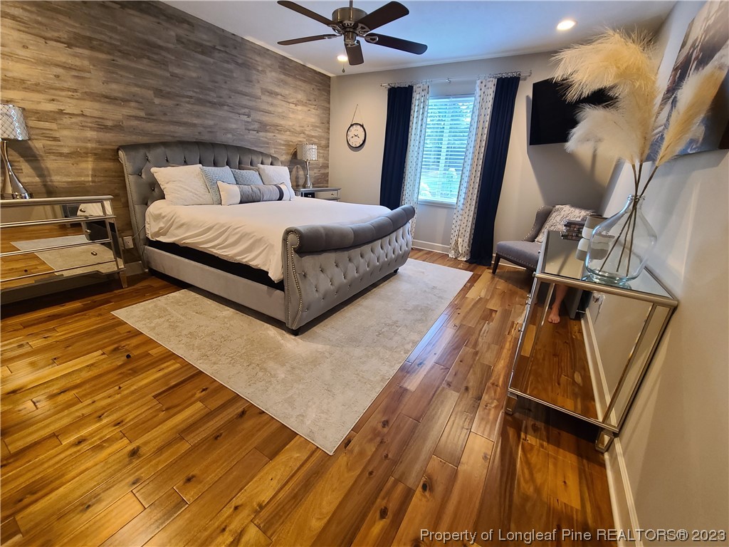 215 Devon Circle Aberdeen, NC 28315 - Photo 18 of 35 a bedroom with a bed and wooden floor
