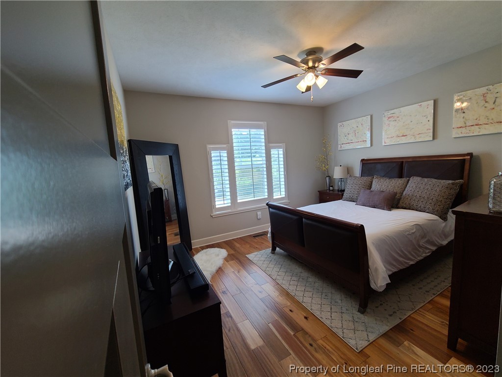 215 Devon Circle Aberdeen, NC 28315 - Photo 21 of 35 a bedroom with a bed a window and potted plant