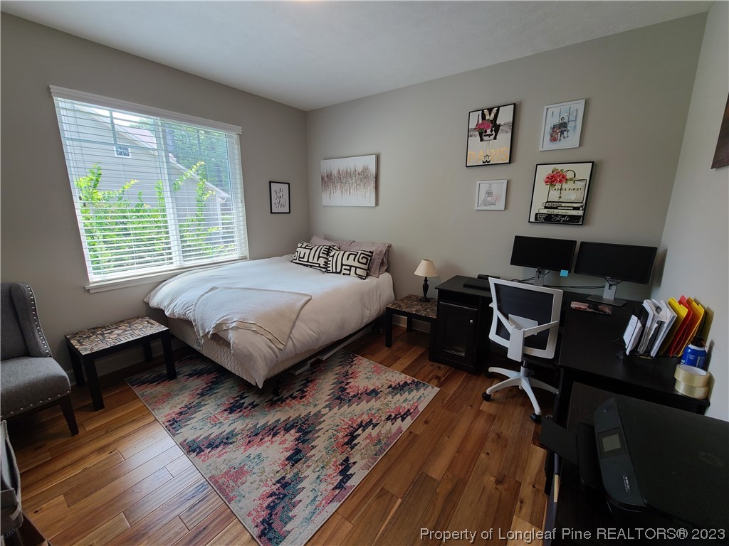 215 Devon Circle Aberdeen, NC 28315 - Photo 25 of 35 a bedroom with a bed and wooden floor