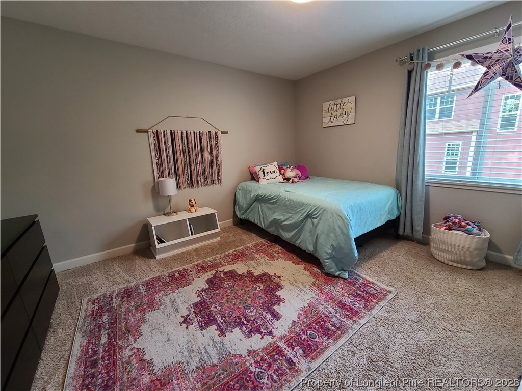 215 Devon Circle Aberdeen, NC 28315 - Photo 29 of 35 a bedroom with a bed and wooden floor