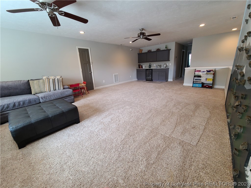 215 Devon Circle Aberdeen, NC 28315 - Photo 30 of 35 a living room with furniture and a chandelier