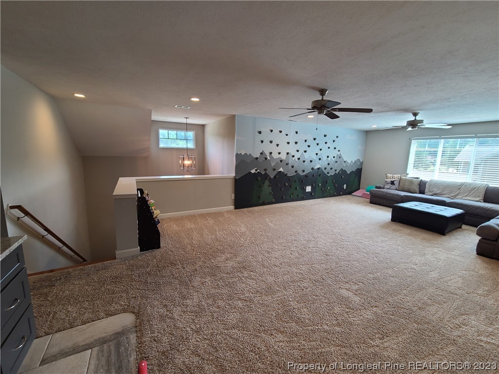 215 Devon Circle Aberdeen, NC 28315 - Photo 31 of 35 a living room with furniture and a chandelier