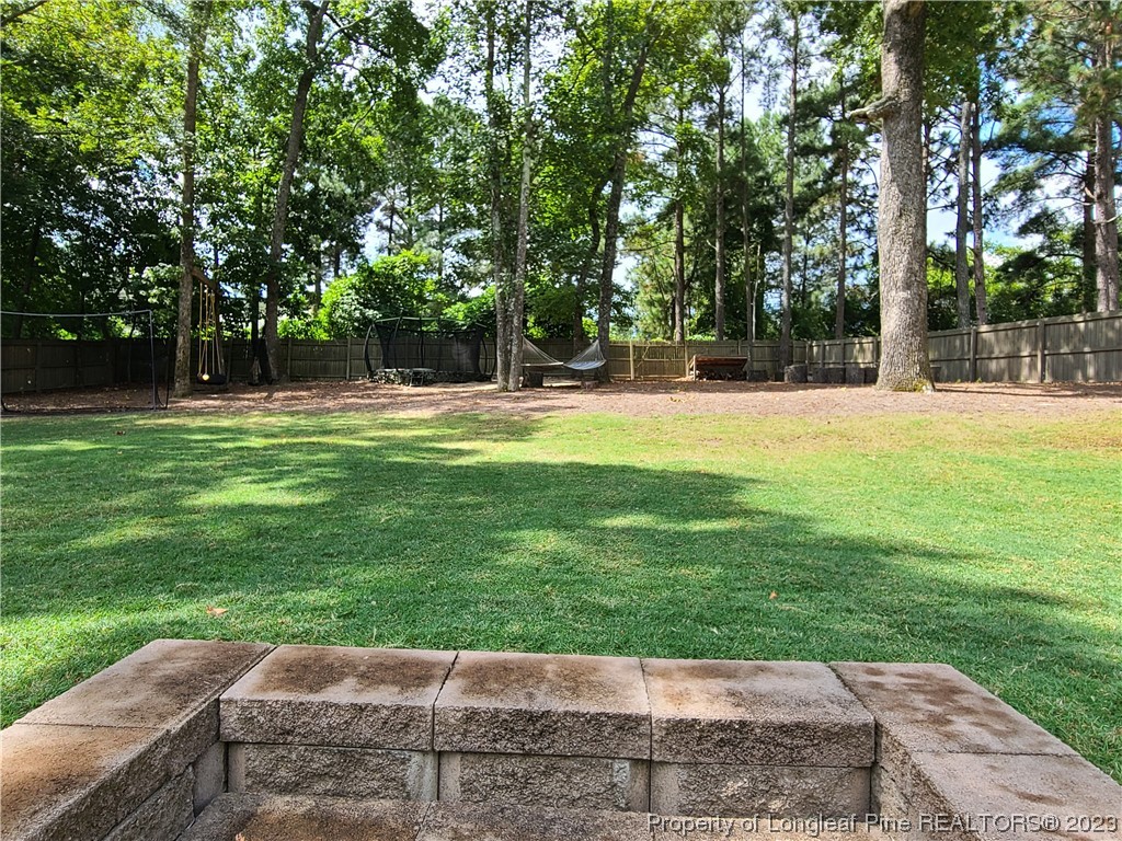 215 Devon Circle Aberdeen, NC 28315 - Photo 35 of 35 a view of a park with trees and wooden fence