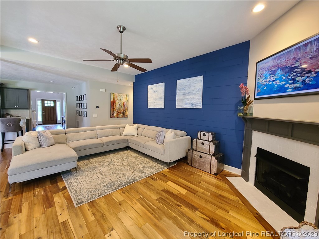 215 Devon Circle Aberdeen, NC 28315 - Photo 5 of 35 a bedroom with a bed a couch and a fireplace