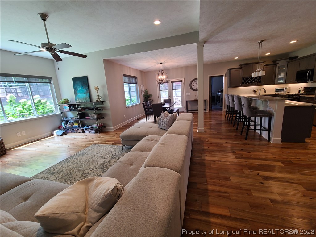 215 Devon Circle Aberdeen, NC 28315 - Photo 8 of 35 a living room with furniture kitchen view and a wooden floor