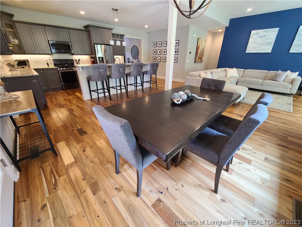 215 Devon Circle Aberdeen, NC 28315 - Photo 9 of 35 a living room with dining room and wooden floor