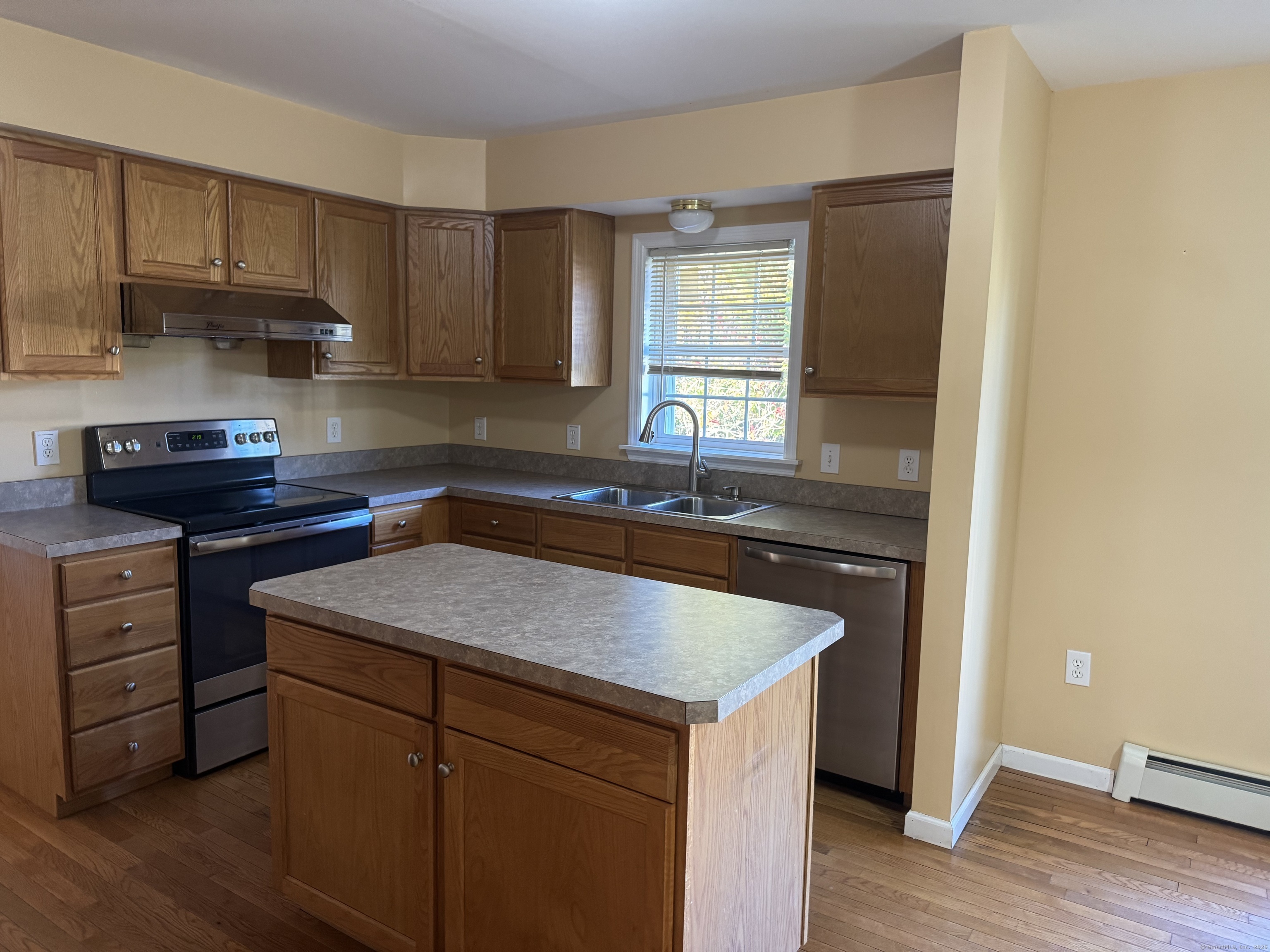 11 Carpenter Street Norwich, CT 06360 - Photo 4 of 12 a kitchen with a sink stove and cabinets