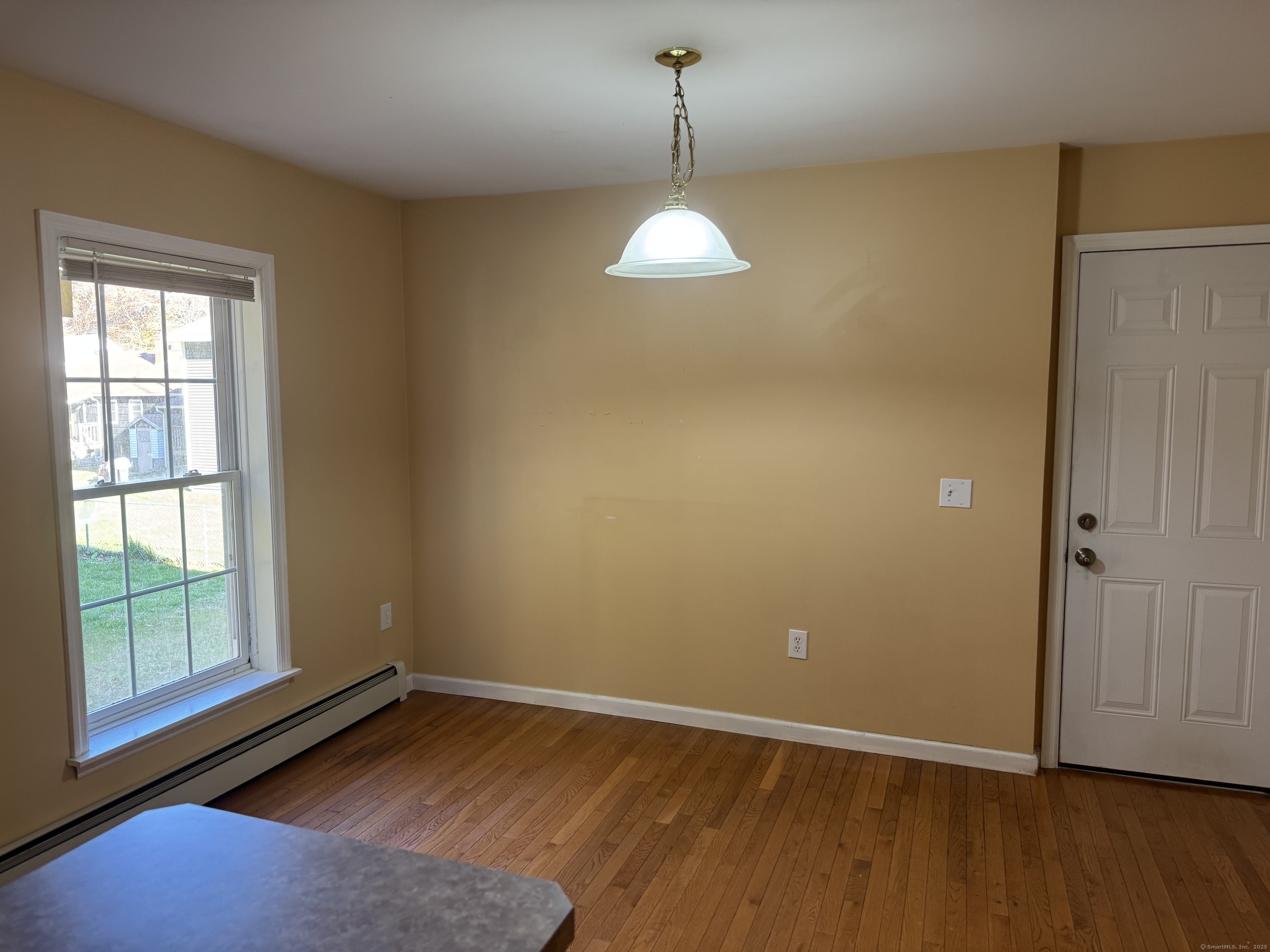 11 Carpenter Street Norwich, CT 06360 - Photo 5 of 12 a view of empty room with wooden floor and fan