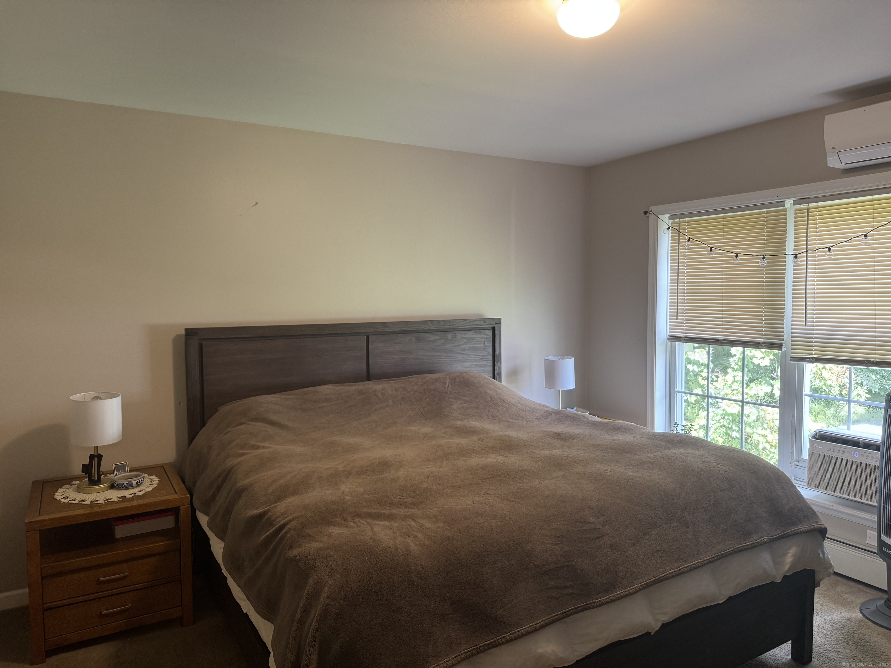 11 Carpenter Street Norwich, CT 06360 - Photo 8 of 12 a bedroom with a bed and a window