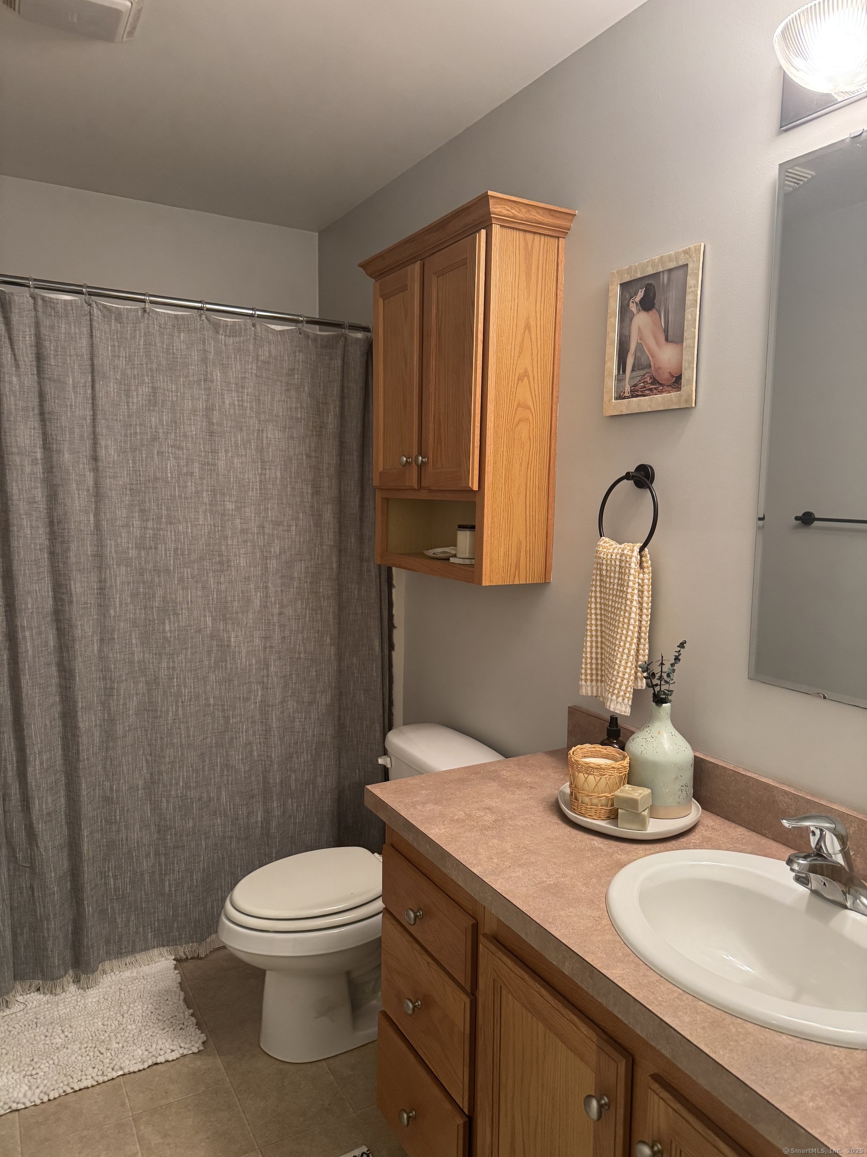 11 Carpenter Street Norwich, CT 06360 - Photo 10 of 12 a bathroom with a granite countertop sink toilet and a mirror
