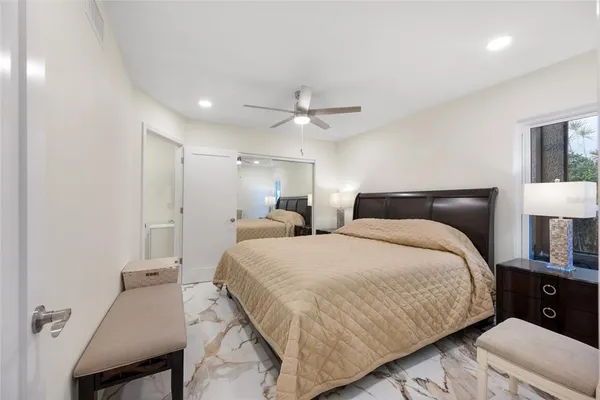 a bedroom with a bed and a lamp