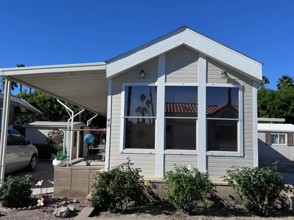 a view of a house with a potted plant and floor to ceiling window and potted plants