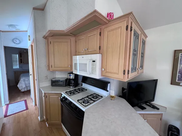 a kitchen with stainless steel appliances a stove a microwave and a cabinets