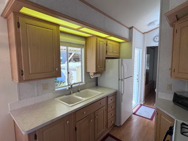 a kitchen with a sink appliances and cabinets