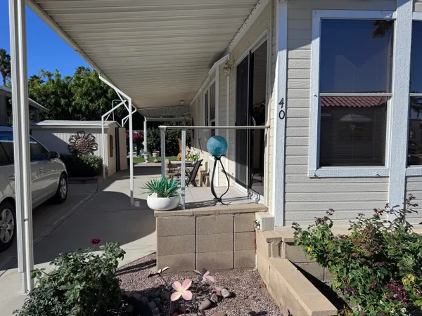 a view of a patio with couches table and chairs and potted plants