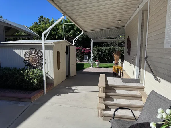 a view of a patio with table and chairs potted plants