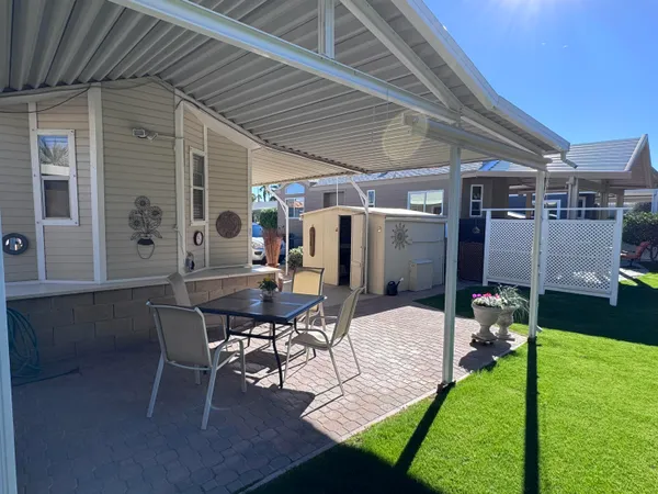 a view of a backyard with furniture and a garden