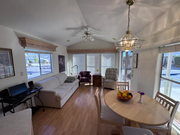 a living room with furniture and a chandelier