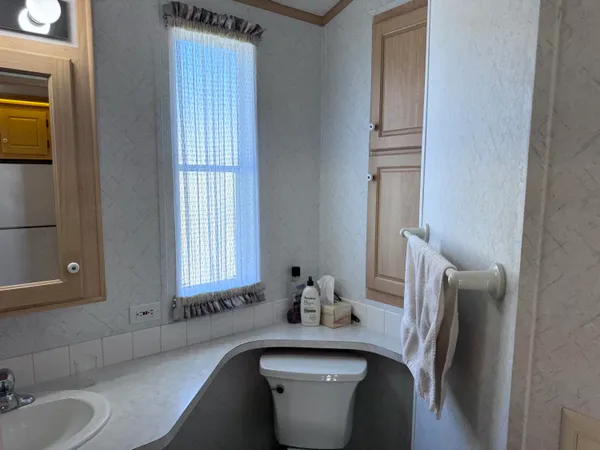a bathroom with a sink a toilet and mirror