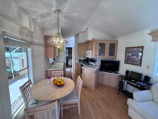 a dining room with furniture a dining table and a chandelier