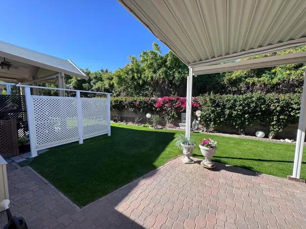 a view of a house with backyard and garden