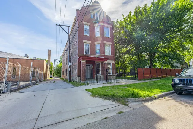 a view of a brick building next to a yard