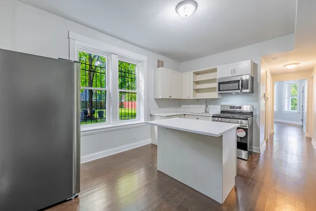a kitchen with stainless steel appliances granite countertop a stove a sink and a refrigerator