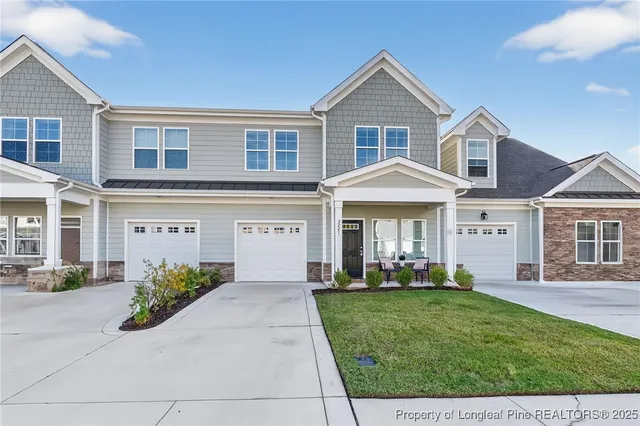 a front view of a house with a yard and garage