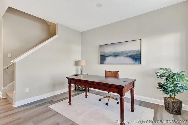 a kitchen with stainless steel appliances granite countertop a stove top oven a sink dishwasher and a refrigerator with wooden floor