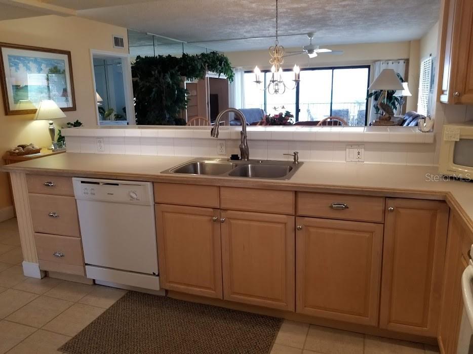 13650 Gulf Boulevard, Unit 304 Madeira Beach, FL 33708 - Photo 17 of 63 a kitchen with cabinets a sink and a window